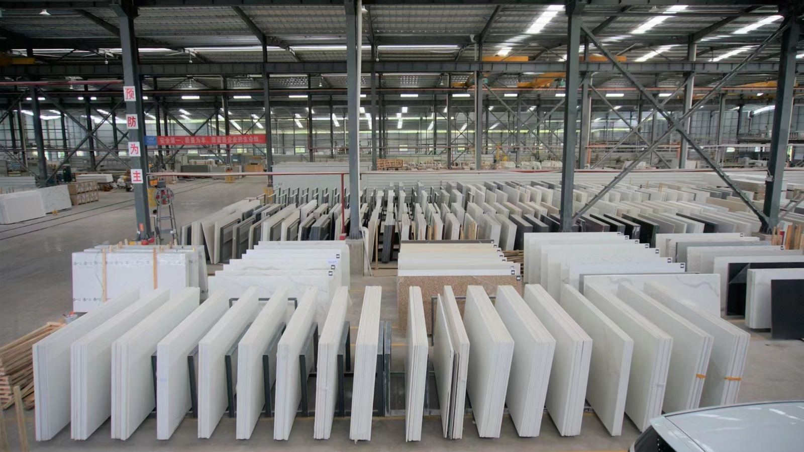 Factory warehouse with rows of stone slabs